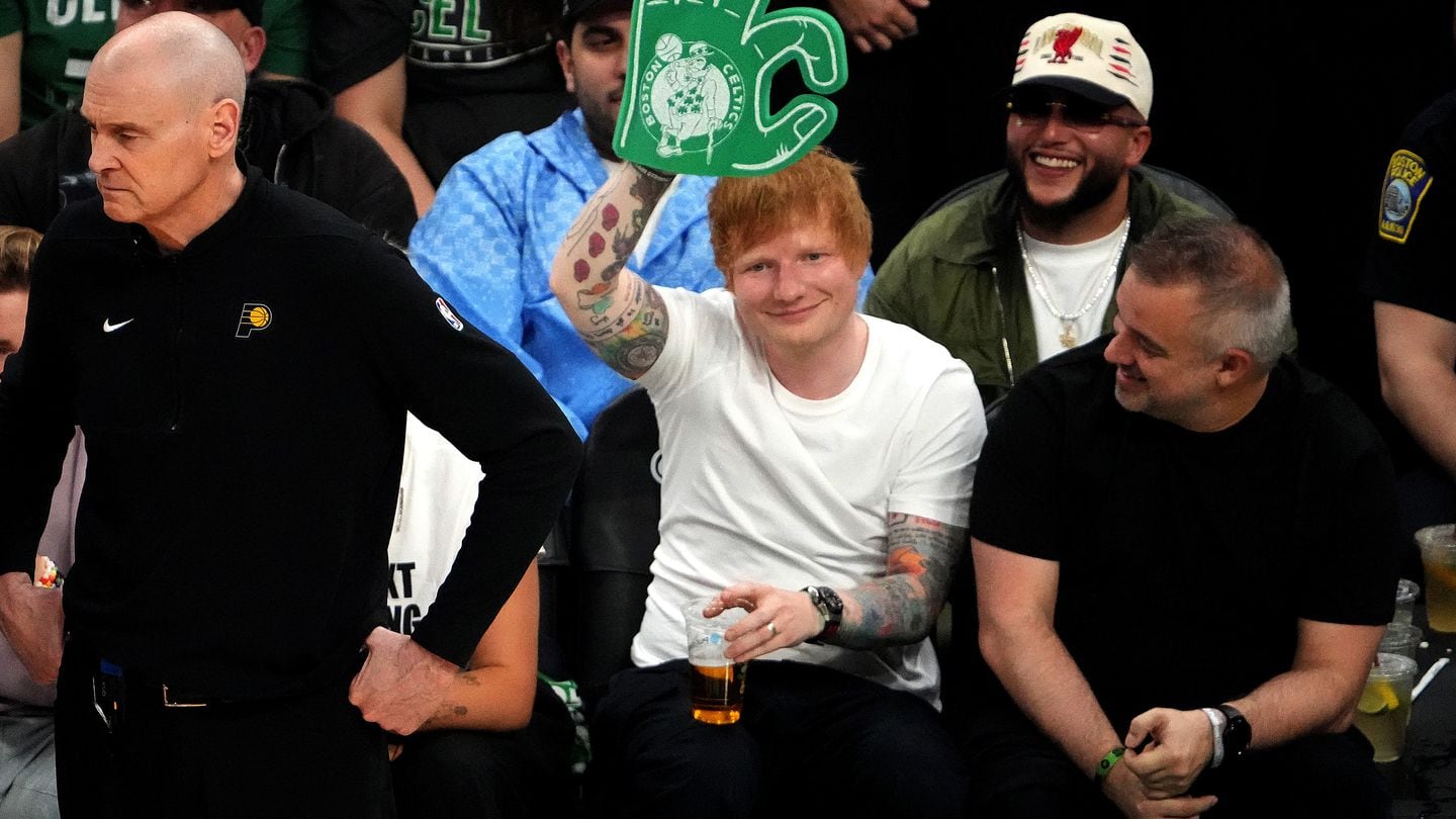 Pop star Ed Sheeran waves to fans during a timeout at the Celtics' playoff game Thursday night at Boston's TD Garden.