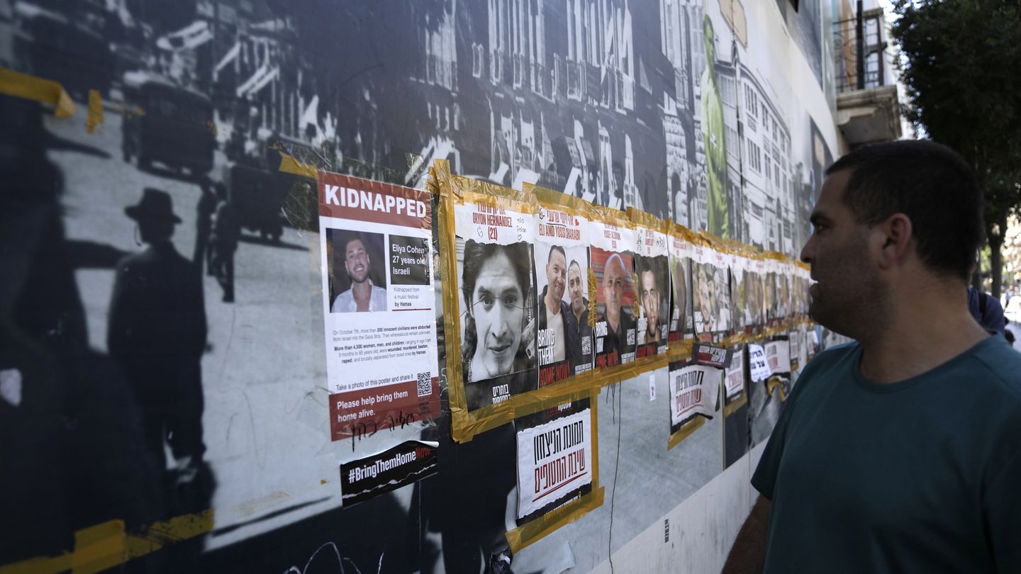 A man looked at posters of hostages held by Hamas in the Gaza Strip, in central Jerusalem, on Friday. The bodies of three more hostages killed on Oct. 7 were recovered overnight from Gaza, Israel’s army said Friday.