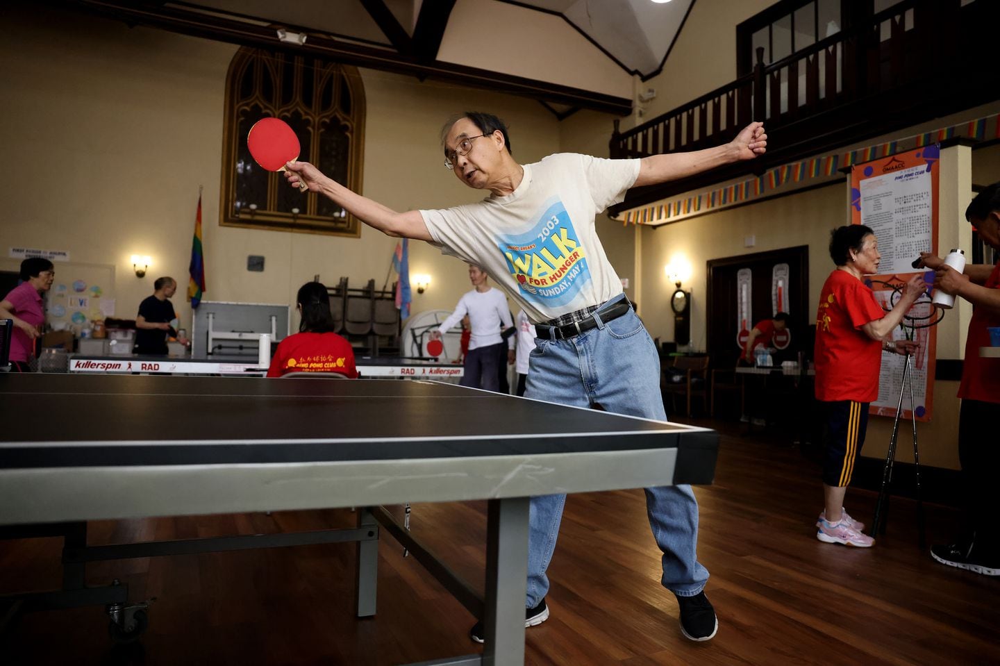 Asian American seniors played ping pong at the First Parish Unitarian Universalist church on May 13.